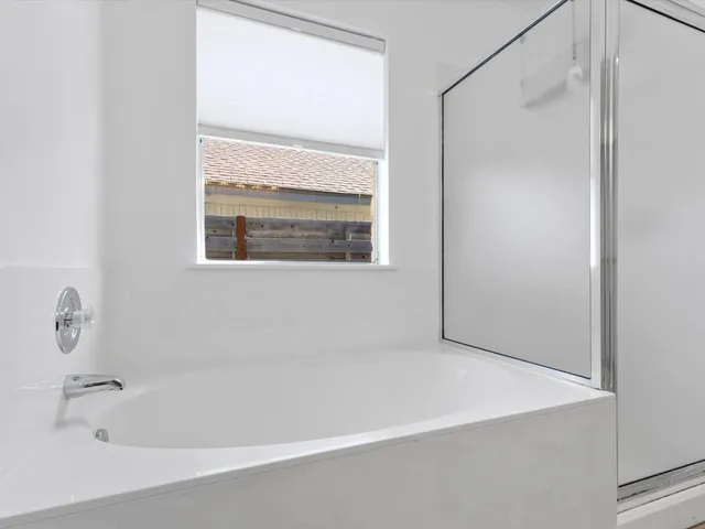 a bathroom with a bathtub and a shower