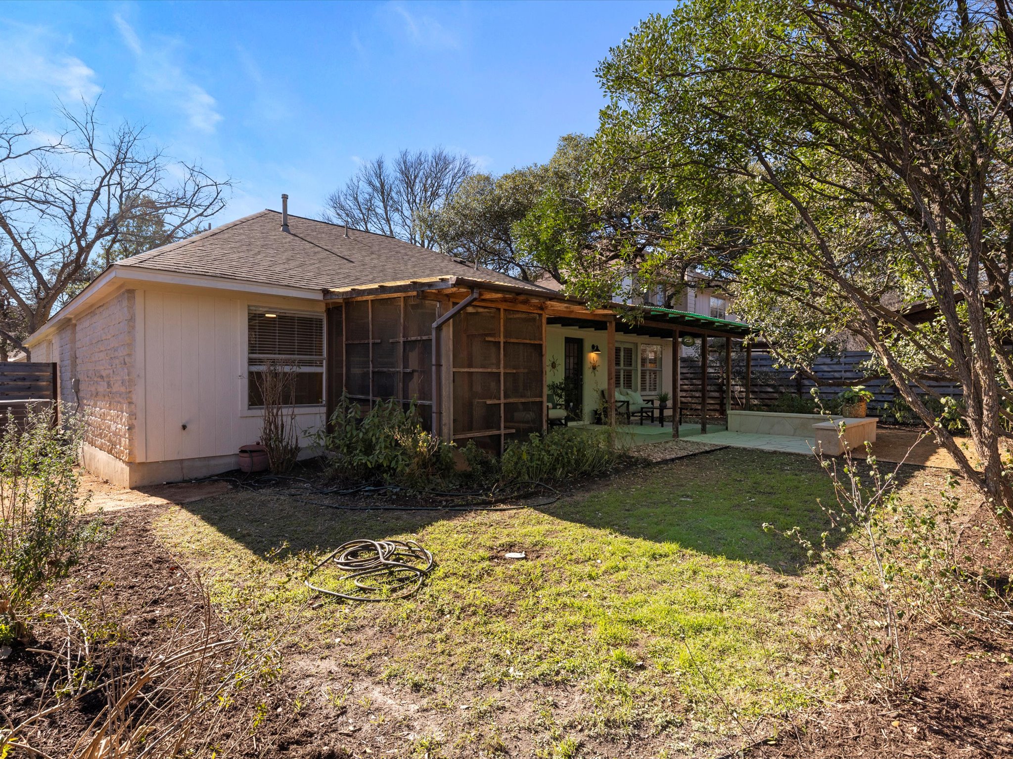 9322 Lightwood Loop Austin, TX 78748 - Photo 36 of 40 The backyard is bordered by mature greenery with just the right amount of lawn space.