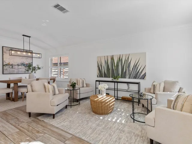 a living room with furniture a rug and white walls