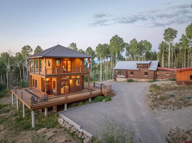 a wooden bench sitting in front of a house
