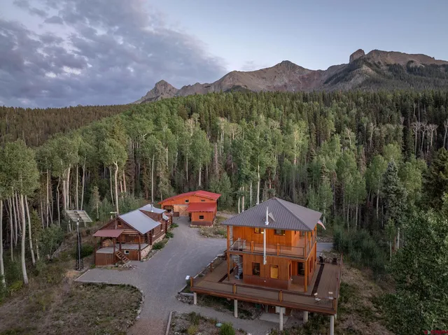 a view of a patio with a table and chairs under an umbrella