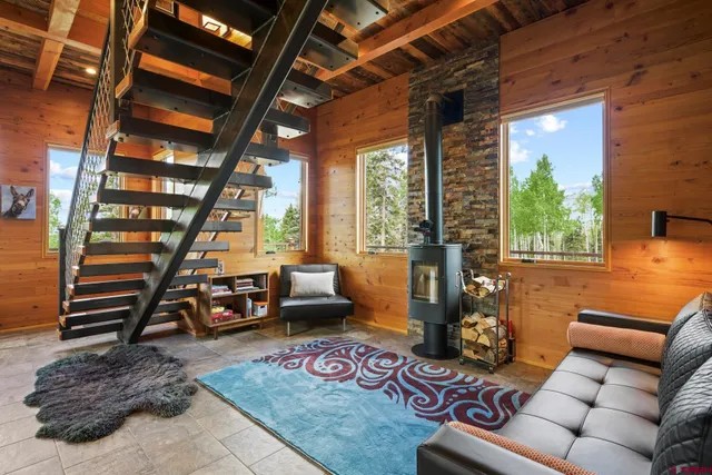 a living room with furniture and a book shelf