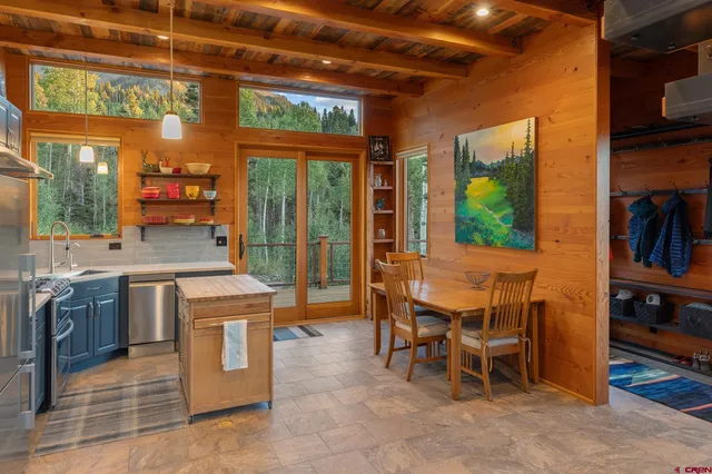 a view of a kitchen with a table and chairs