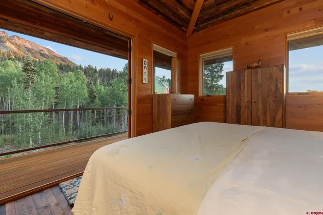 a bedroom with a bed and large window