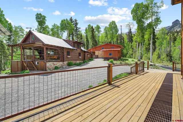 a view of a wooden deck and a yard