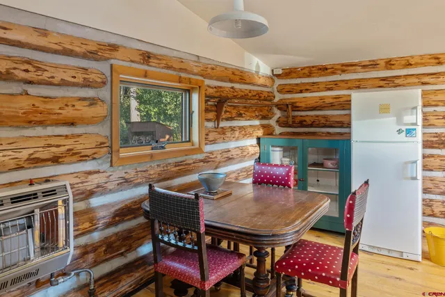 a roof deck with table and chairs and wooden floor