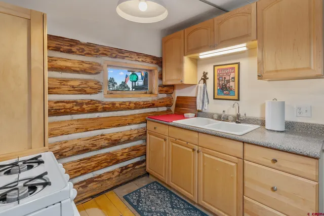 a kitchen with sink and cabinets