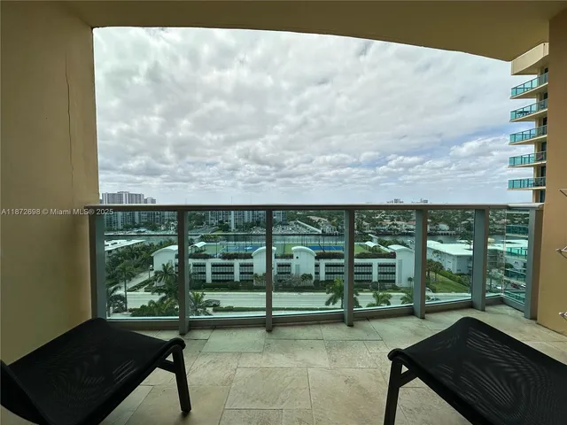 a view of a balcony with chairs and a table