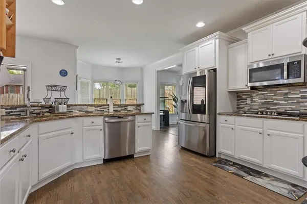 a kitchen with kitchen island a counter top space a sink and appliances