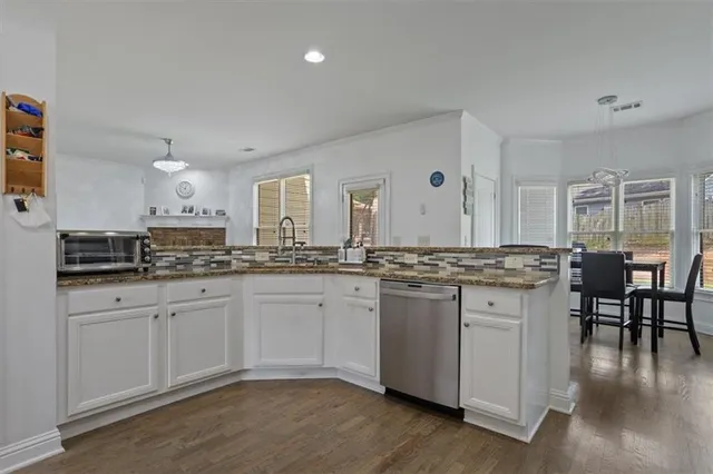 a living room with furniture a fireplace and wooden floor