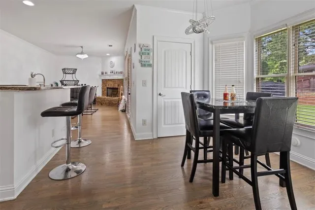 a view of a dining room with furniture window and wooden floor