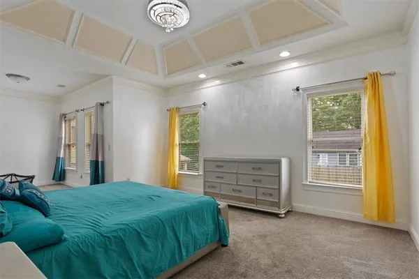 a large white kitchen with a sink and cabinets