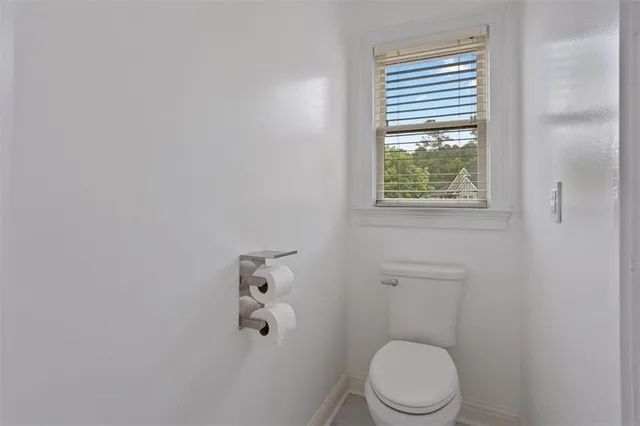 a bathroom with a sink toilet and a mirror