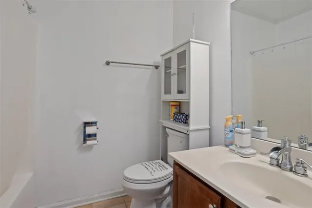 a white toilet sitting next to a bathroom sink
