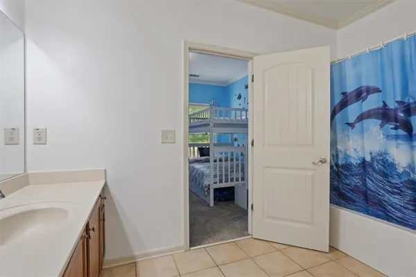 an aerial view of a house with a yard and basket ball court