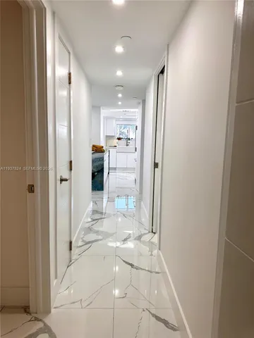 a view of a hallway with wooden shelves