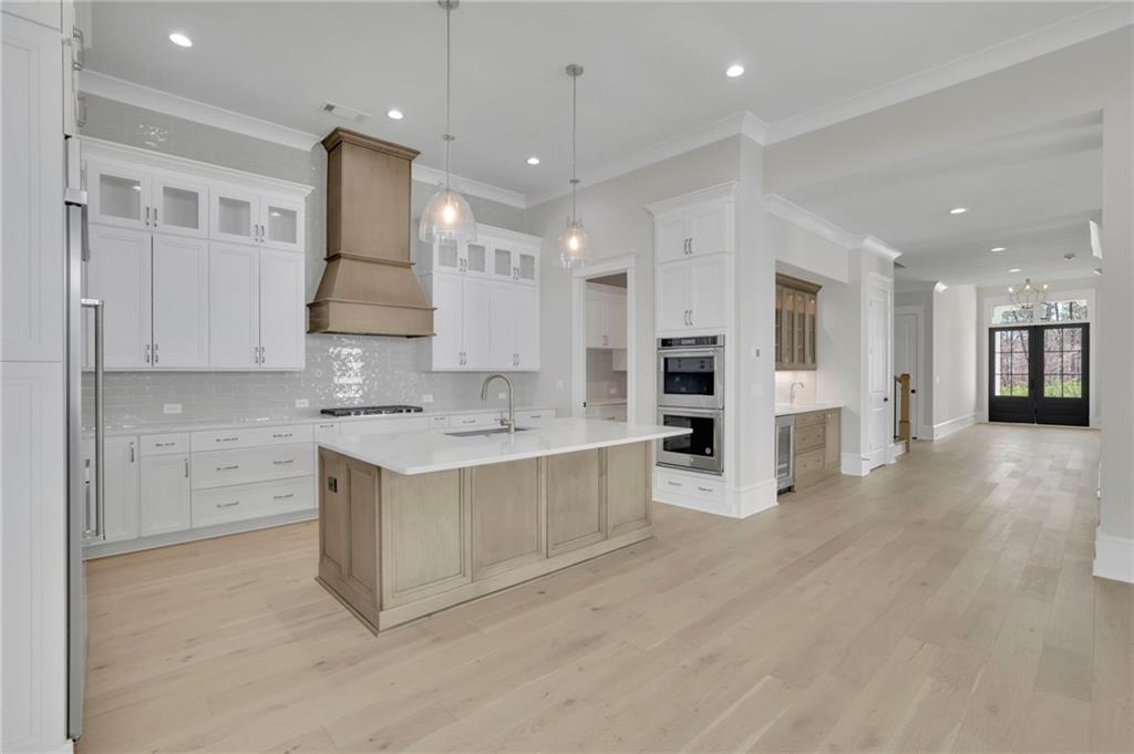 123 Candler Loop Acworth, GA 30101 - Photo 14 of 34 a large kitchen with stainless steel appliances kitchen island granite countertop a large counter top and a stove top oven