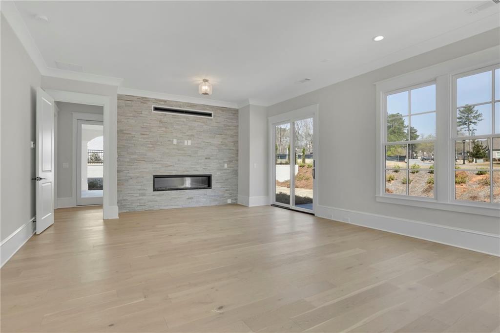 123 Candler Loop Acworth, GA 30101 - Photo 28 of 34 an empty room with windows and fireplace