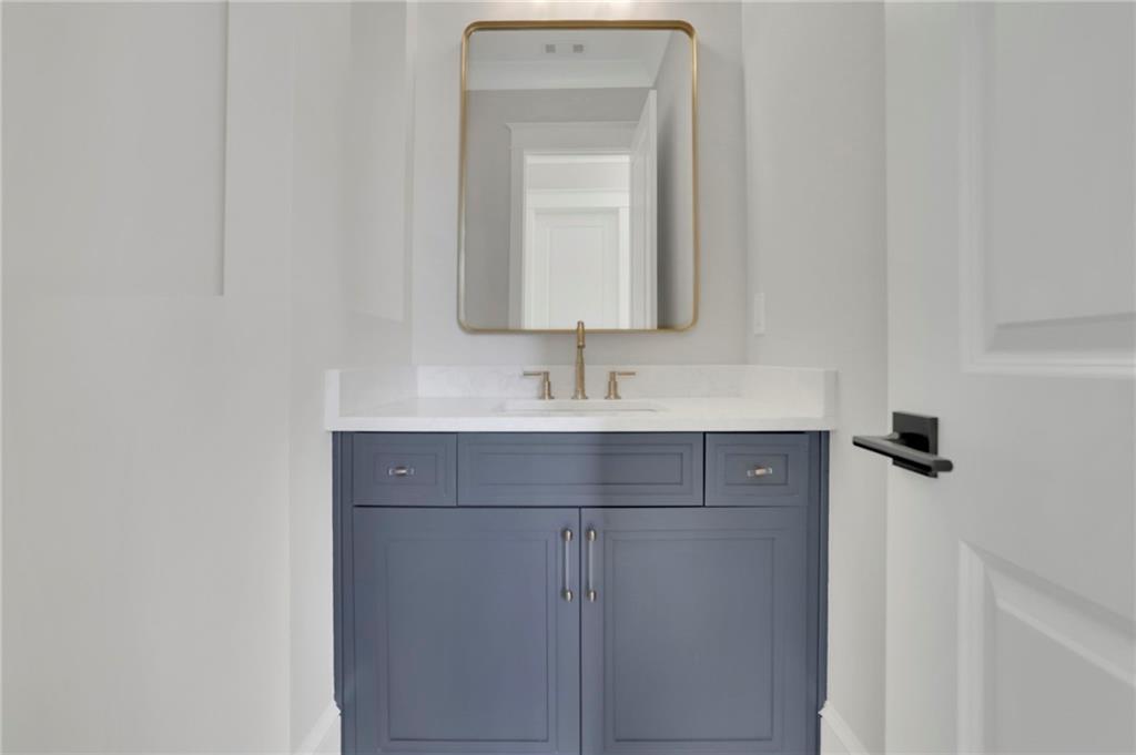123 Candler Loop Acworth, GA 30101 - Photo 32 of 34 a bathroom with a sink and a mirror