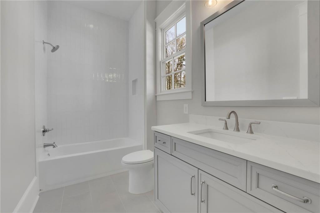 123 Candler Loop Acworth, GA 30101 - Photo 33 of 34 a bathroom with a granite countertop sink a toilet and a bathtub