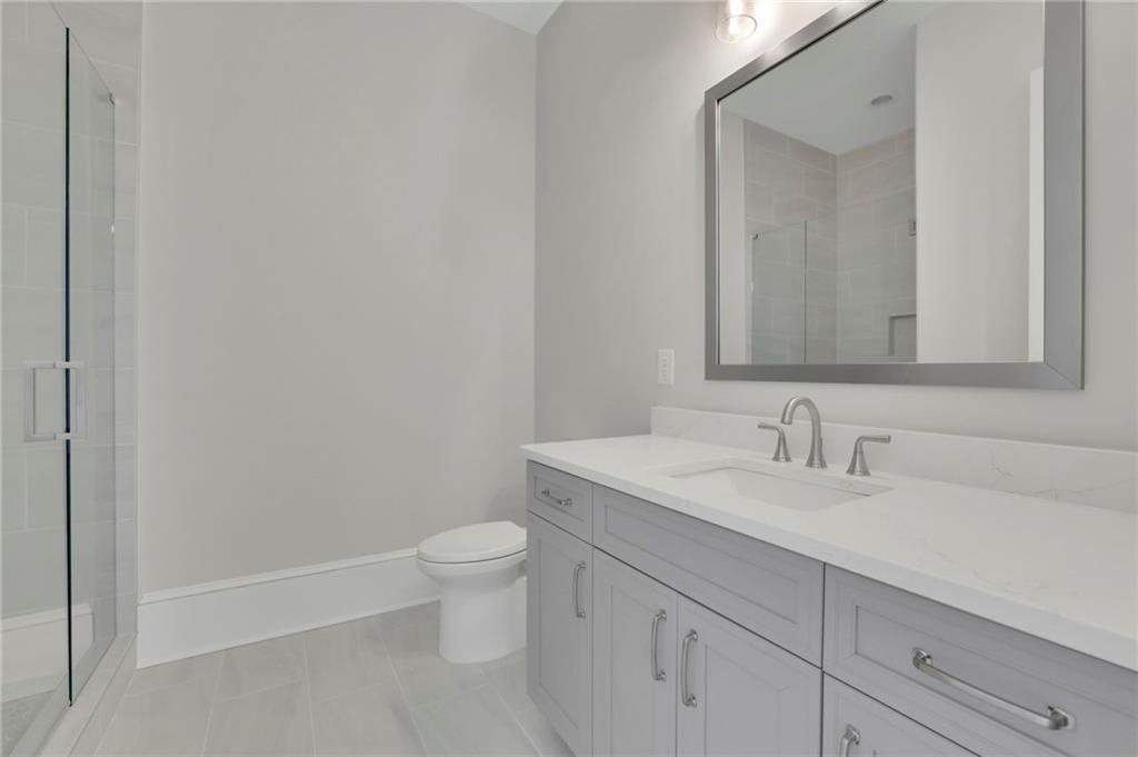 123 Candler Loop Acworth, GA 30101 - Photo 8 of 34 a bathroom with a granite countertop sink a toilet and a mirror