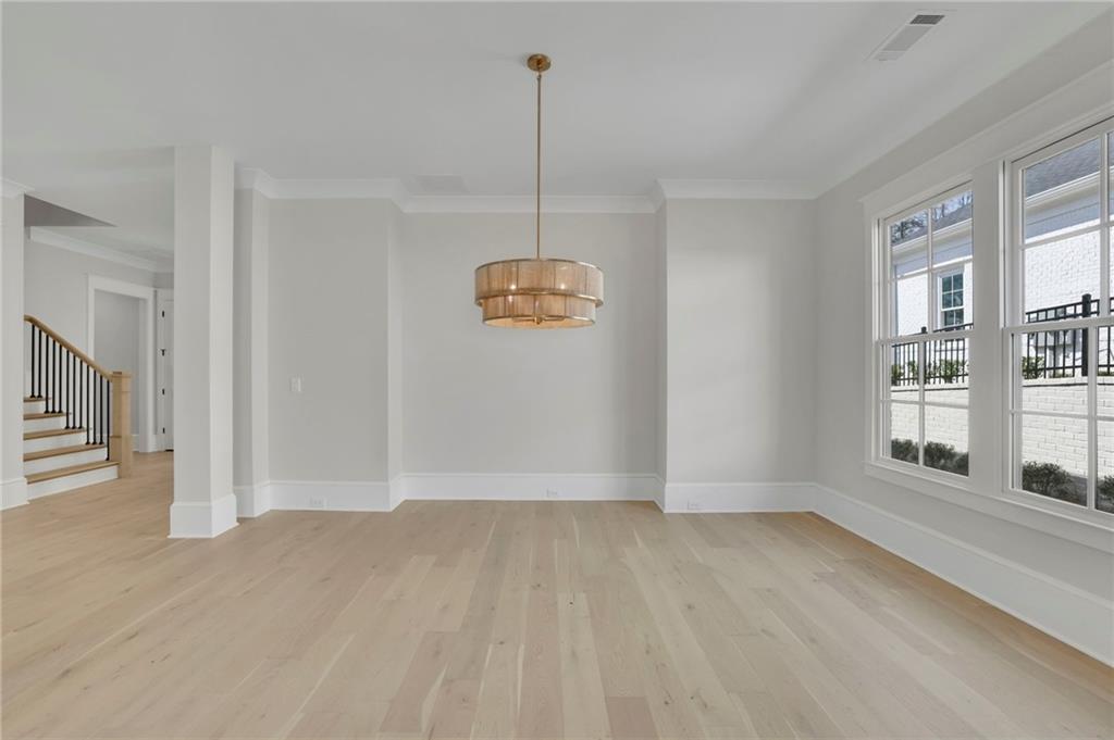 123 Candler Loop Acworth, GA 30101 - Photo 10 of 34 a view of empty room with wooden floor and fan