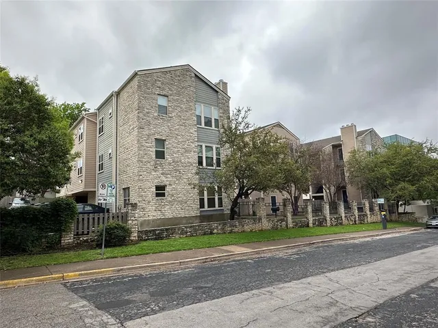 a front view of a building with tree s