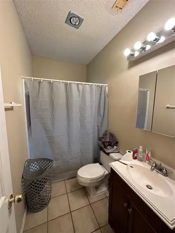 a bathroom with a sink a toilet a mirror and shower