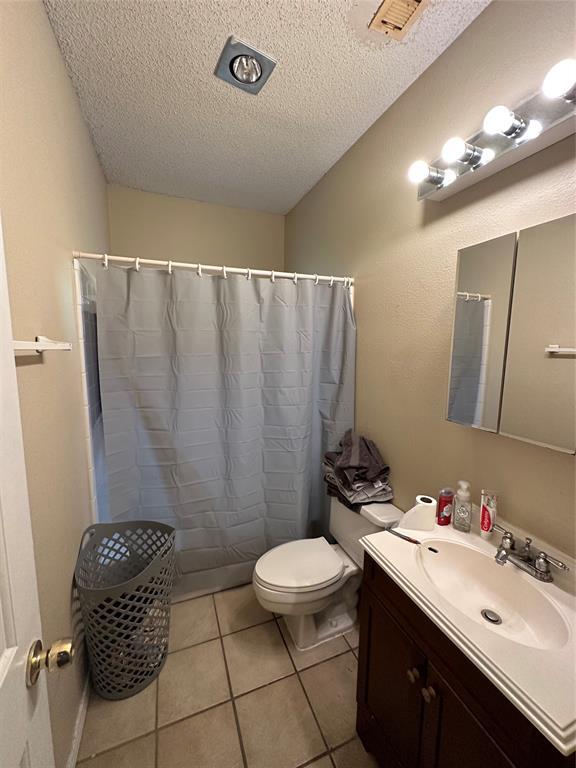 2414 Longview Street, Unit 301 Austin, TX 78705 - Photo 14 of 15 a bathroom with a sink a toilet a mirror and shower