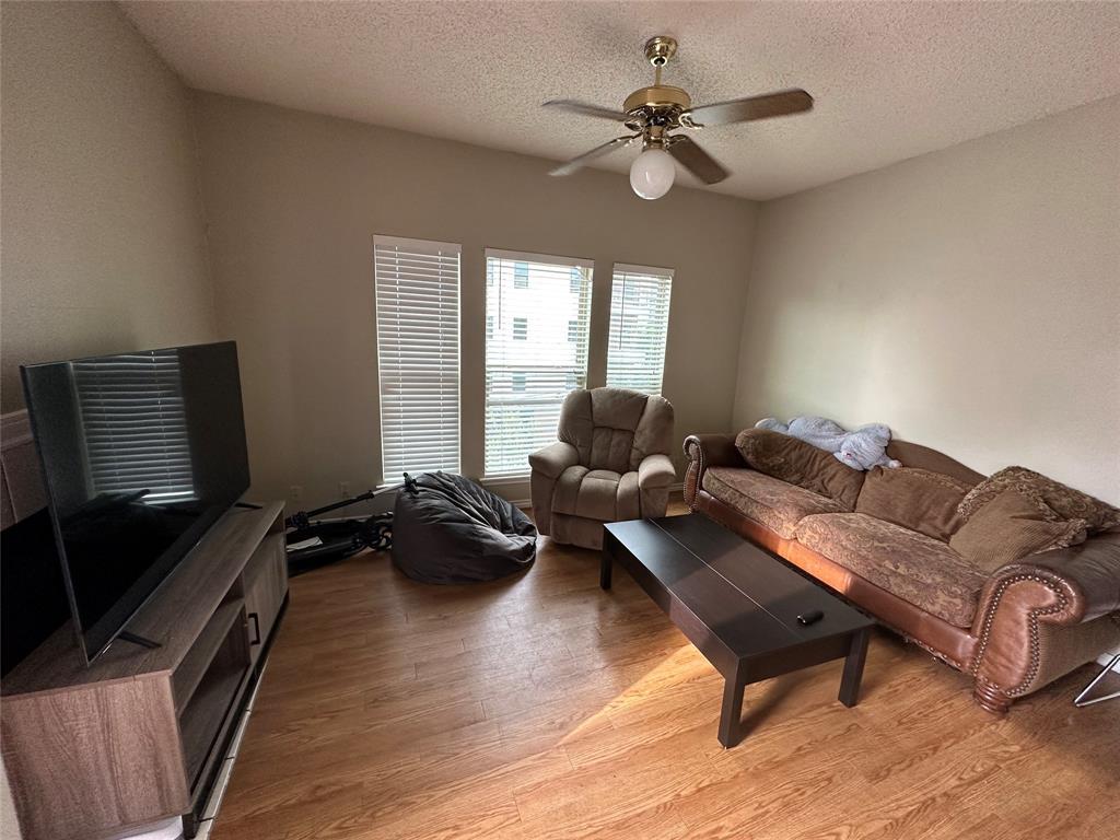2414 Longview Street, Unit 301 Austin, TX 78705 - Photo 2 of 15 a living room with furniture ceiling fan and a window