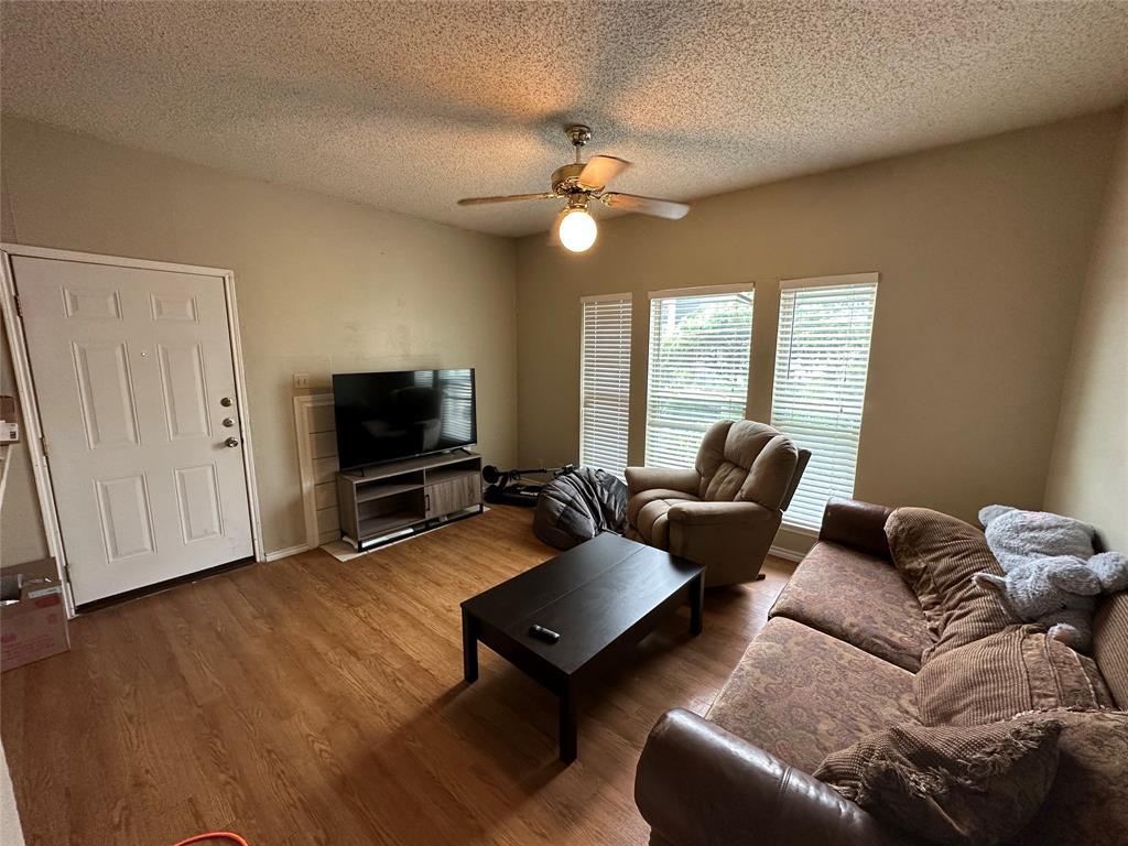 2414 Longview Street, Unit 301 Austin, TX 78705 - Photo 3 of 15 a living room with furniture and a flat screen tv