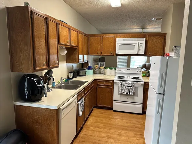 a kitchen with a sink stove and refrigerator