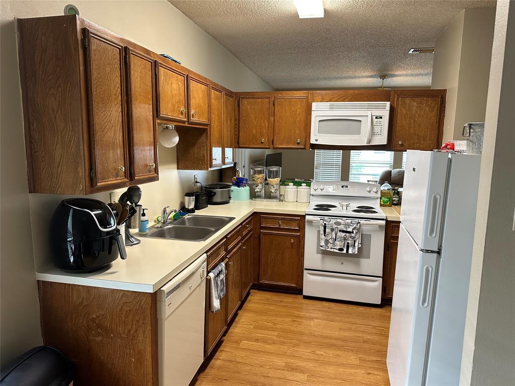2414 Longview Street, Unit 301 Austin, TX 78705 - Photo 5 of 15 a kitchen with a sink stove and refrigerator