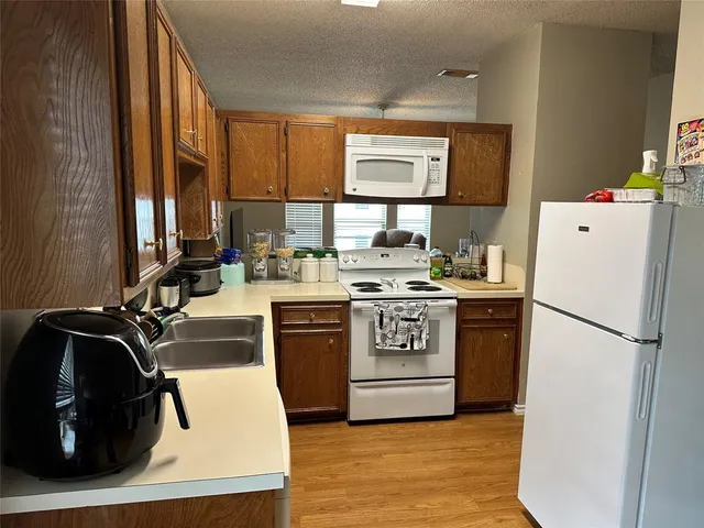 a kitchen with a refrigerator and a sink