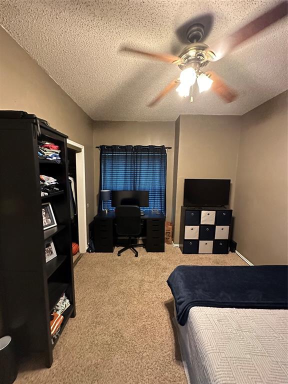 2414 Longview Street, Unit 301 Austin, TX 78705 - Photo 9 of 15 a bedroom with a bed and a television