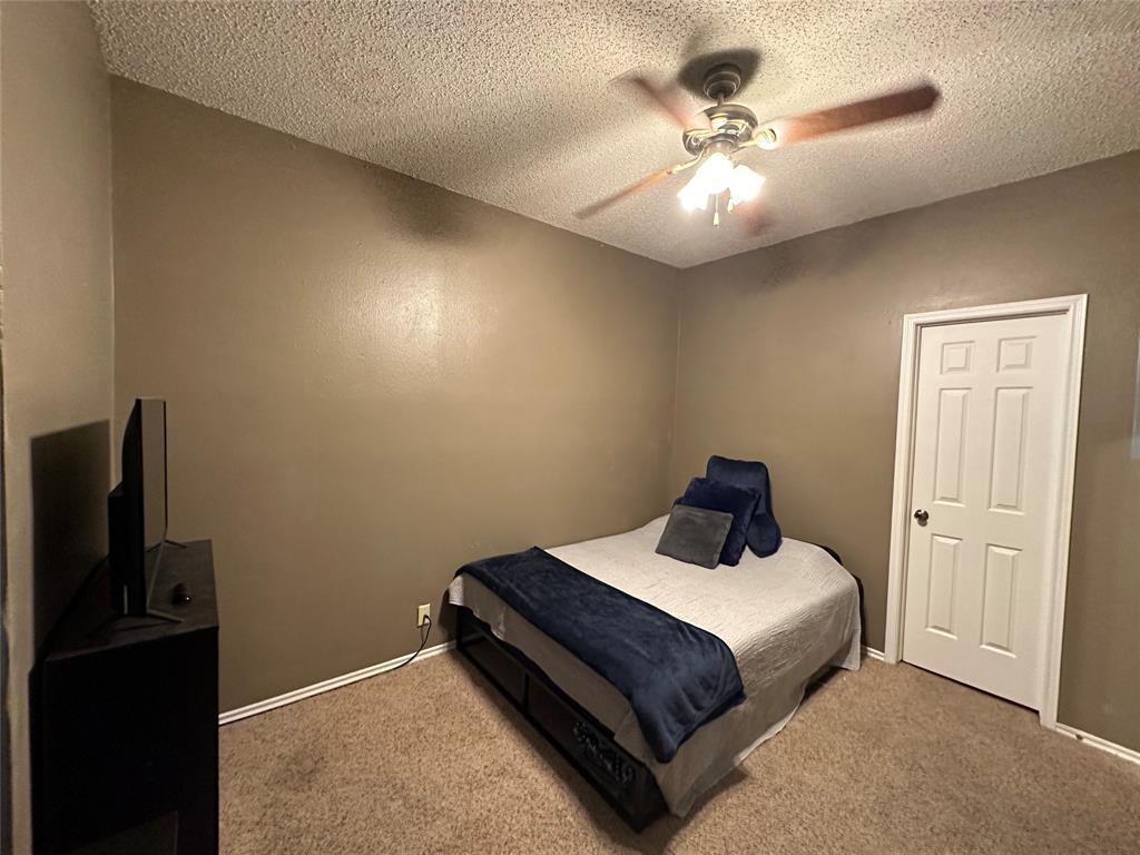 2414 Longview Street, Unit 301 Austin, TX 78705 - Photo 10 of 15 a bedroom with a bed and a chandelier