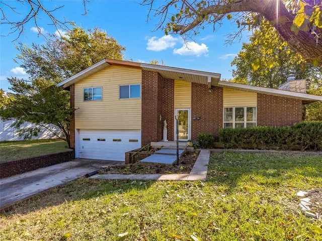 a front view of house with yard and outdoor seating