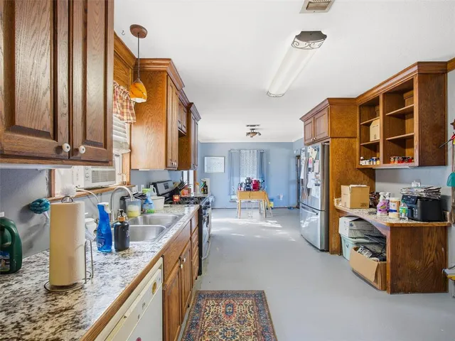 a kitchen view of a counter top space and stainless steel appliances
