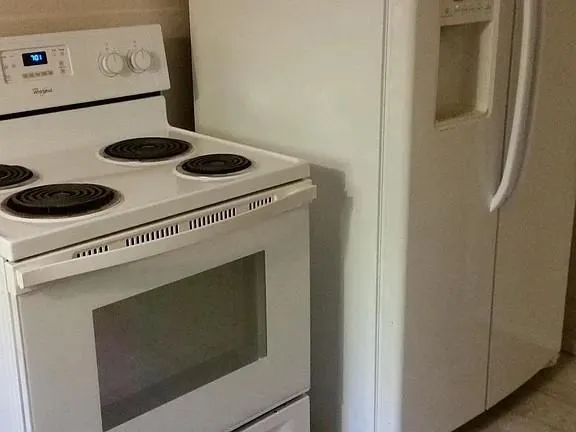 a stove top oven sitting inside of a kitchen