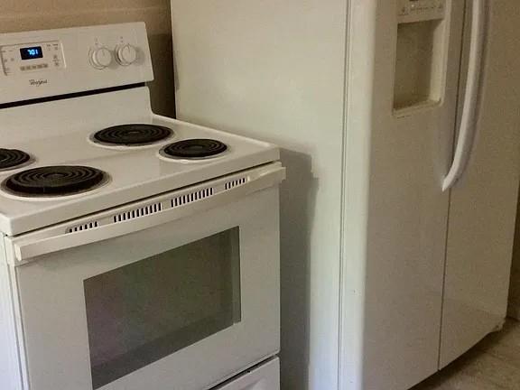 304 Fulton Street, Unit A Denton, TX 76201 - Photo 16 of 17 a stove top oven sitting inside of a kitchen