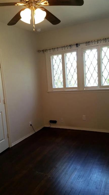 304 Fulton Street, Unit A Denton, TX 76201 - Photo 5 of 17 a view of an empty room with wooden floor and windows