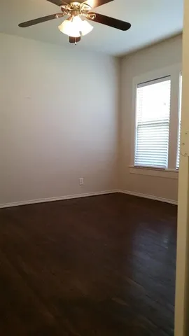 a view of a room with wooden floor and windows