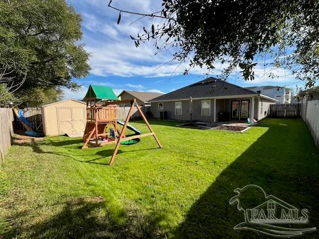 a view of a backyard with wooden fence