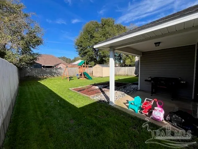 a view of a storage house with yard