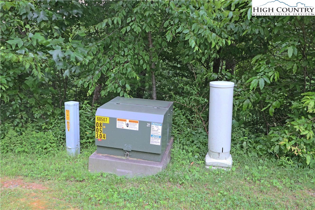 Nettles Ridge, Unit 45 Banner Elk, NC 28604 - Photo 3 of 12 a front view of a house with a yard and trees