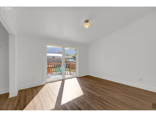 a view of an empty room and wooden floor