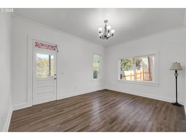 a view interior of a house with wooden floor windows and a chandelier