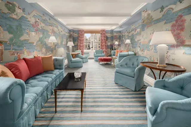 a living room with furniture and a lamp