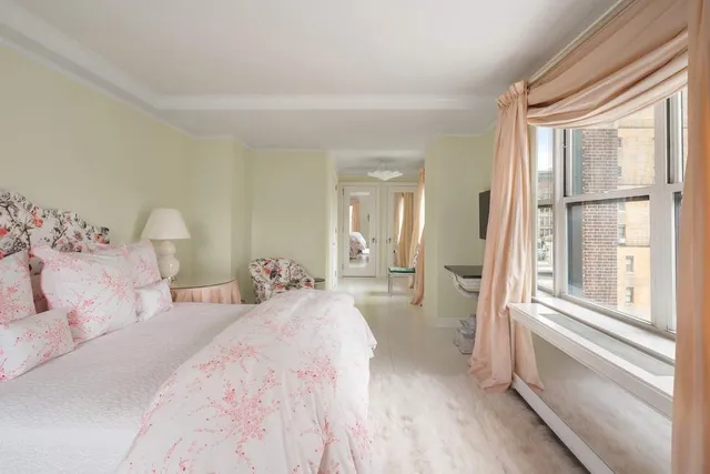 a en suite spacious bedroom with a bed and glass door