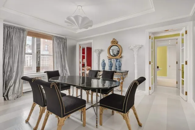 a dining room with furniture a chandelier and wooden floor